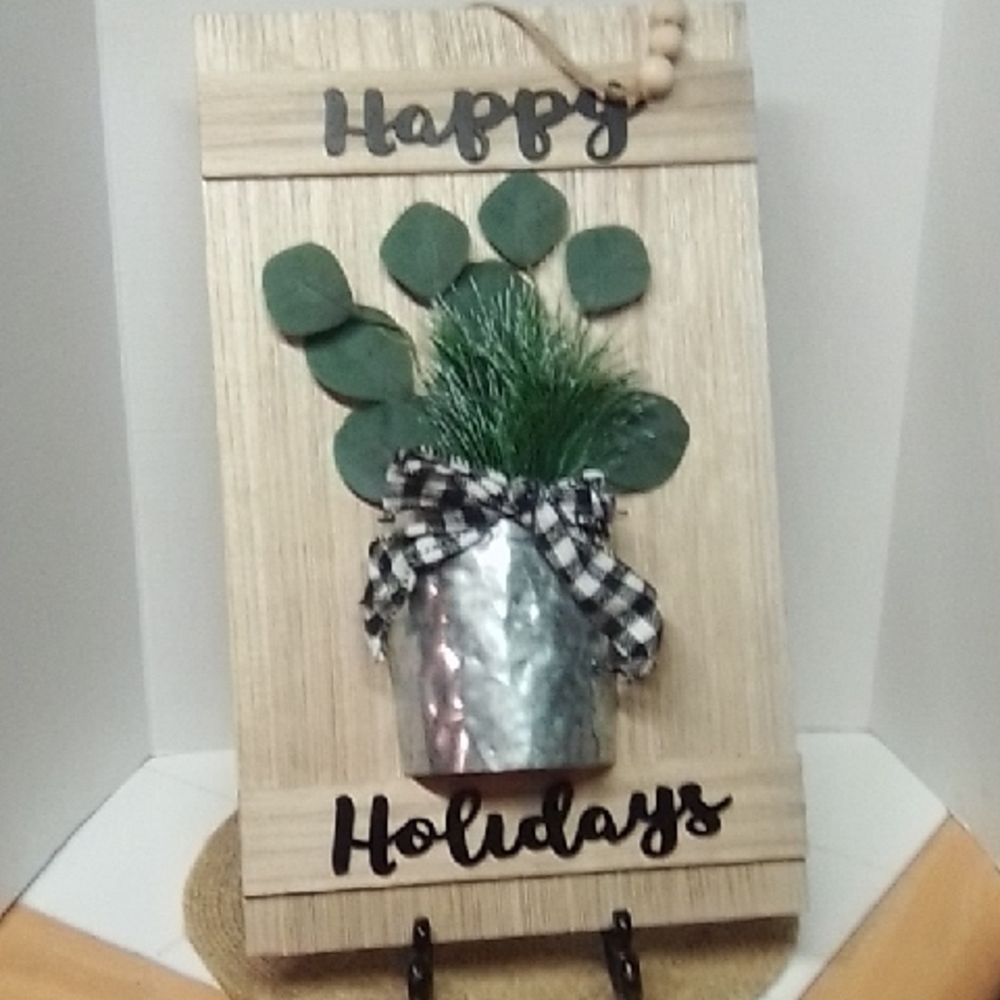 Festive Holiday Wall Decor with Greenery and Silver Accents